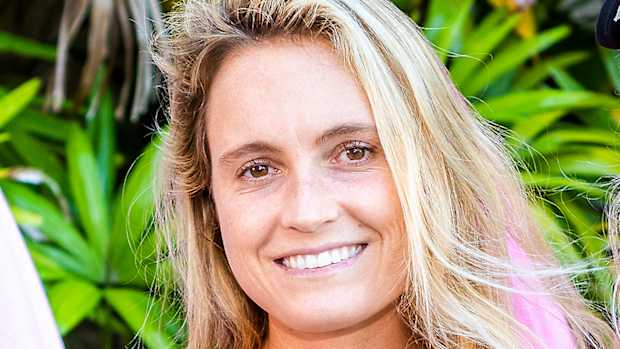 Alana Blanchard poses with her blonde hair down in a relaxed wave and smiles for the camera.
